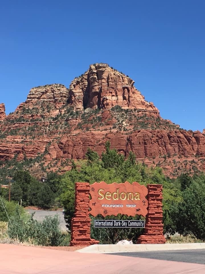 Visitors enjoying a scenic overlook in Sedona's red rock landscape