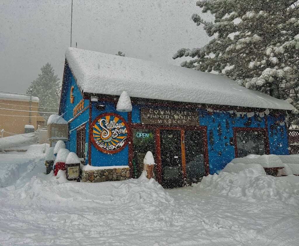 Outdoor seating and colorful sign of Stellar Brew & Natural Café