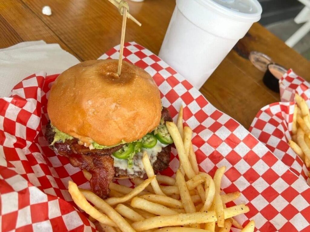 A burger and fried shrimp basket served with fries at The Spot, a popular beachfront restaurant in Galveston