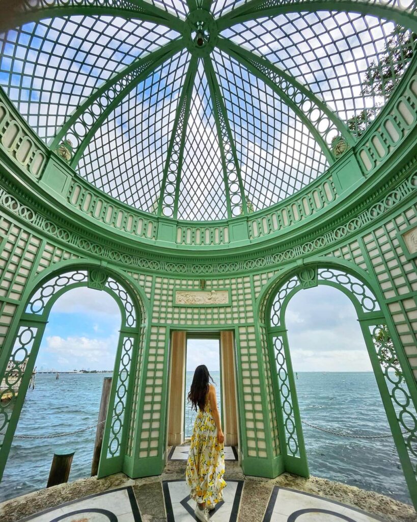 Stone terrace at Vizcaya Museum & Gardens in Miami with view of Biscayne Bay and manicured hedges.