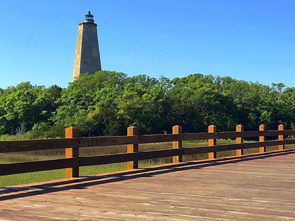 .Wooden boardwalk winding through the Bald Head Island Conservancy marsh.