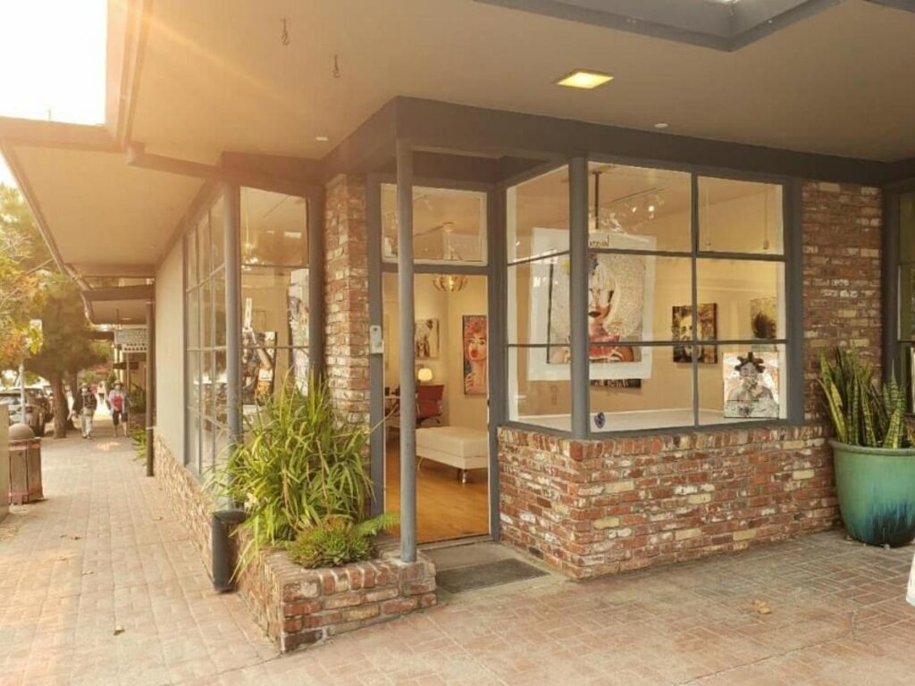 People browsing art galleries along a quiet street in Carmel-by-the-Sea.