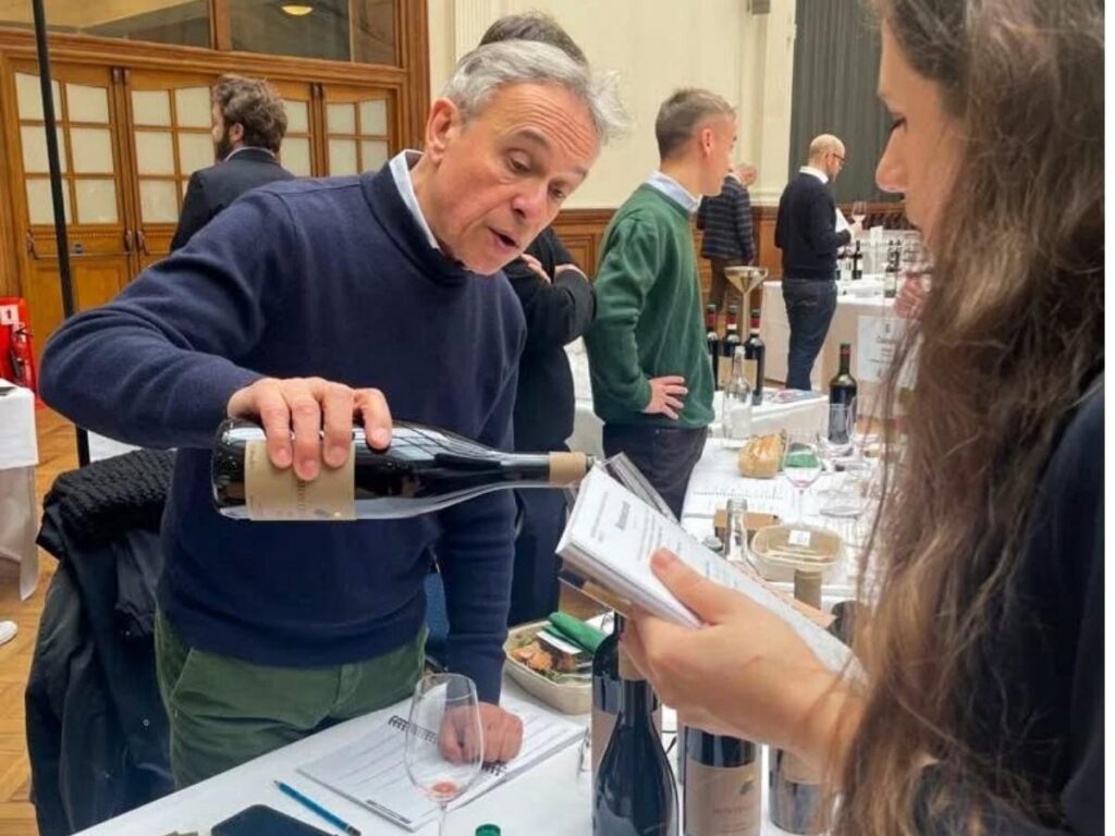 A wine flight on a wooden table with warm evening light inside a Carmel tasting room