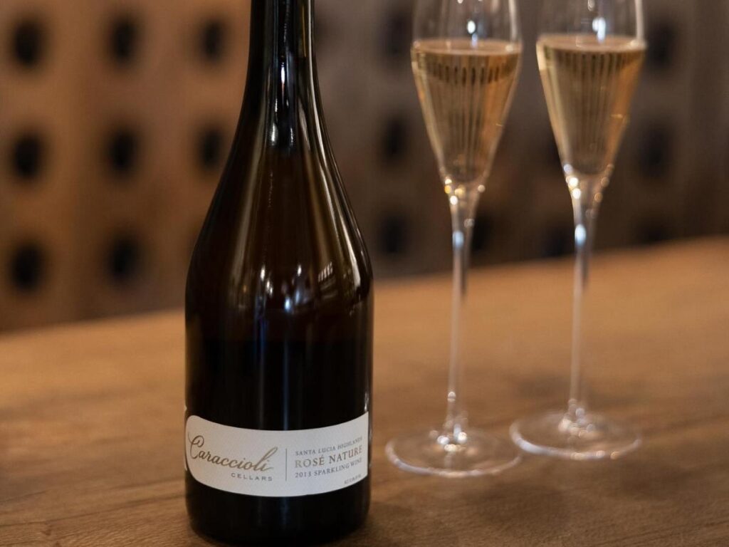 A small wine tasting flight on a wooden board inside a Carmel tasting room