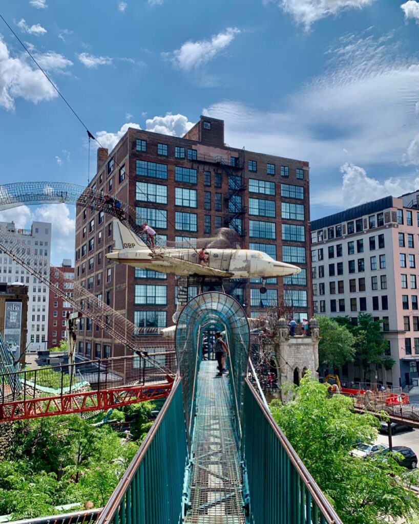 Kids and adults climbing through metal tunnels and slides at City Museum St. Louis