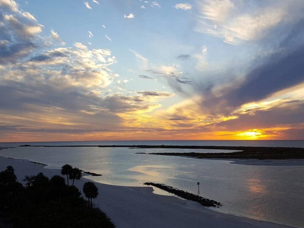 Quiet undeveloped beach on Keewaydin Island with shallow water and no buildings