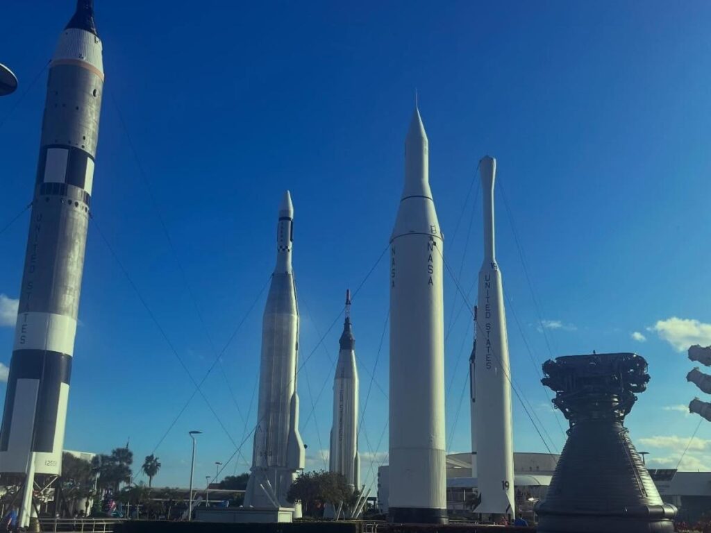 Outdoor rocket display at Kennedy Space Center in Florida under clear skies