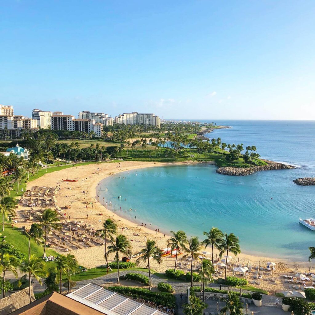 Serene Ko Olina Lagoon with palm-lined beach and gentle waves in Kapolei, Oahu
