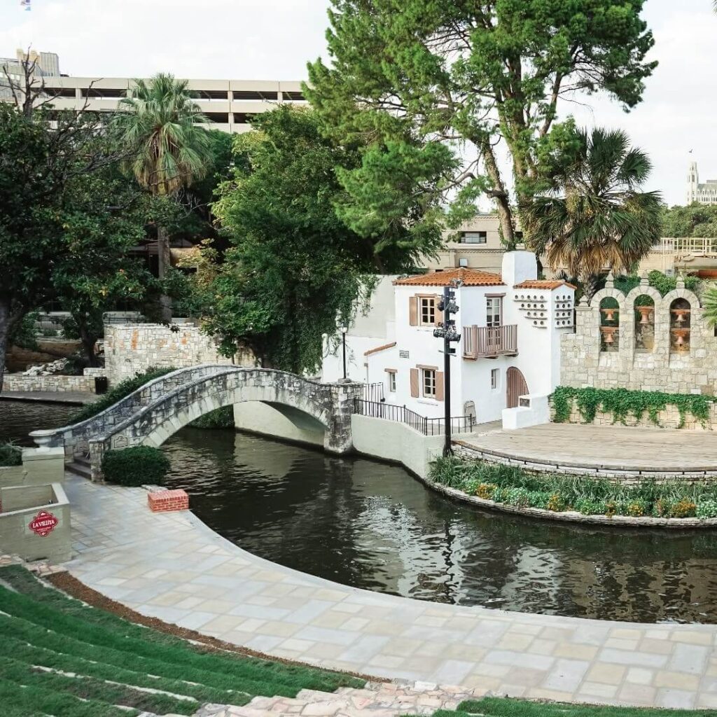Cobblestone street with colorful doors, art galleries, and hanging plants in La Villita Historic Arts Village