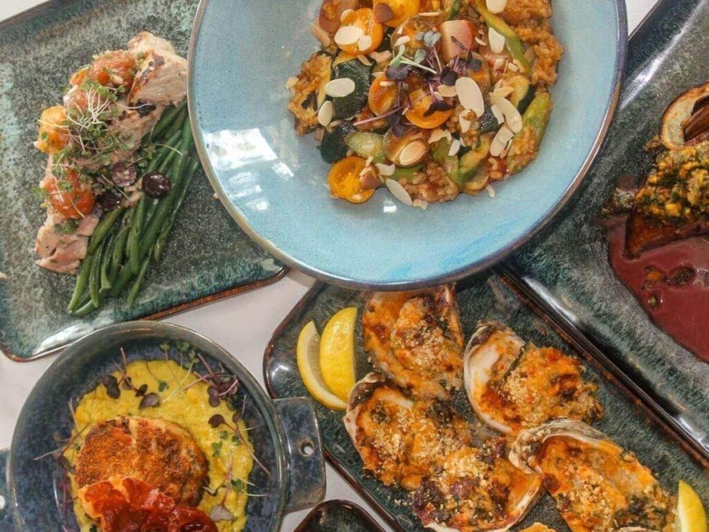 Outdoor table at a Bald Head Island restaurant with seafood on the menu.