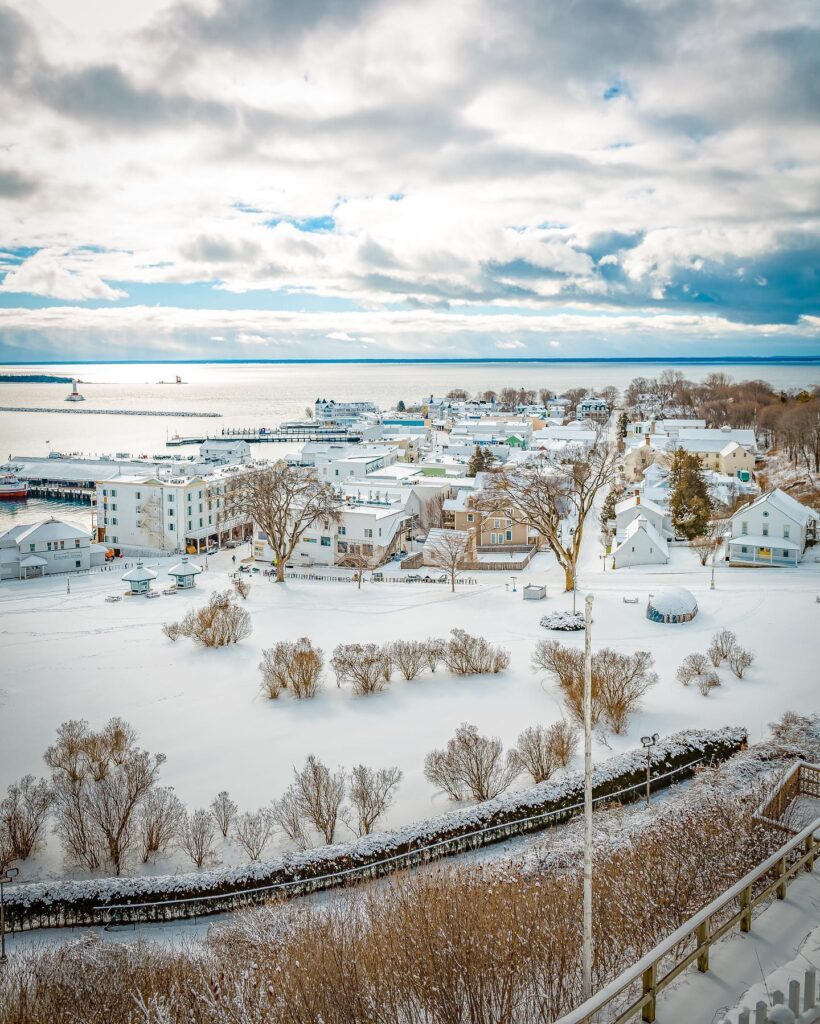 Snow-covered Main Street on Mackinac Island with horse-drawn sleigh and historic buildings