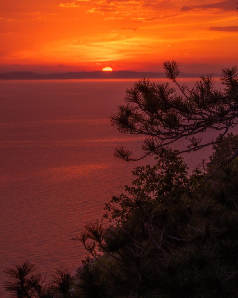Sunset over Lake Huron seen from Windermere Point with pink and orange skies