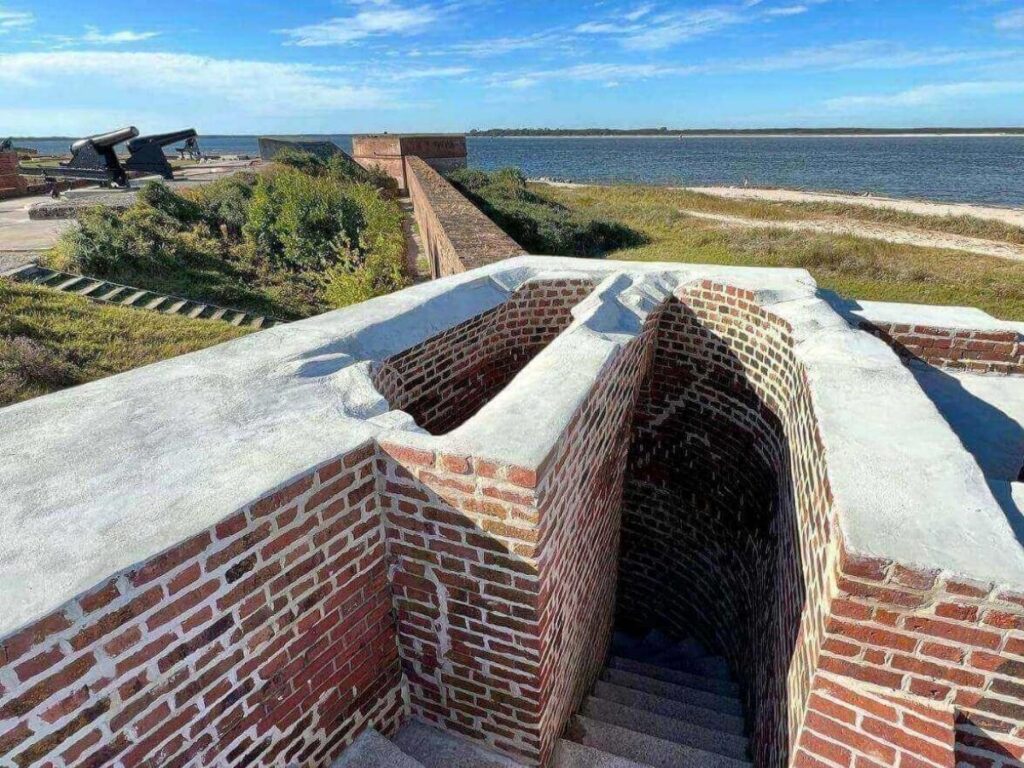 Historic brick walls and cannons at Fort Clinch overlooking the beach