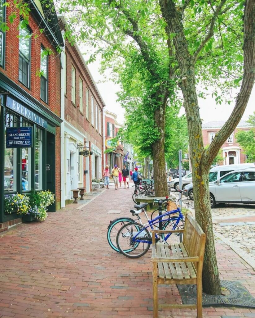 Cobblestone street in downtown Nantucket lined with boutiques and historic buildings.