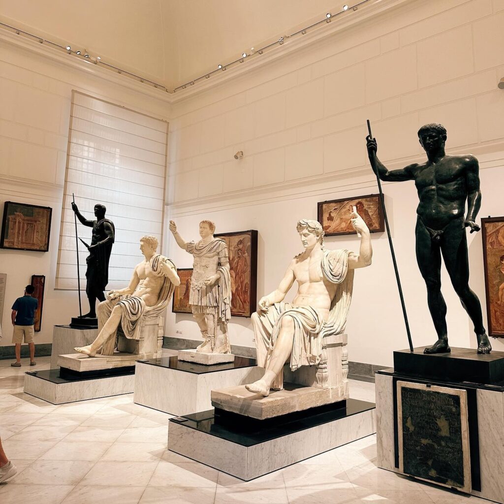 Ancient Roman mosaics and sculptures displayed inside the Naples Archaeological Museum