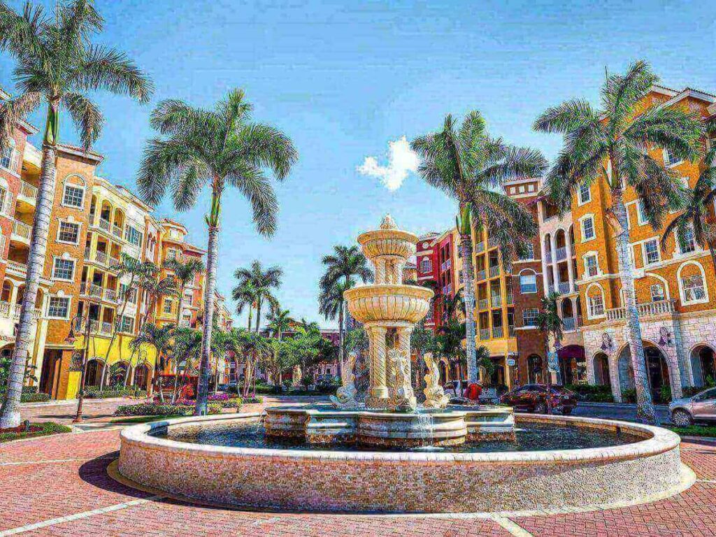 Street view in downtown Naples with shops and palm trees