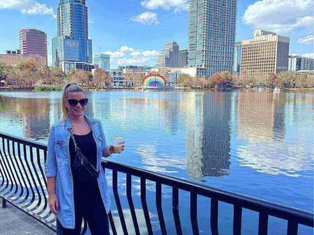 People walking along a lake in Orlando during the early evening after a warm day