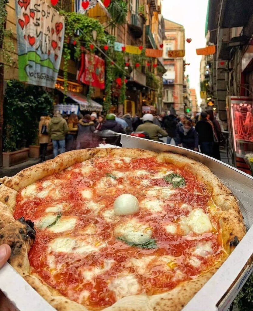 A fresh margherita pizza with blistered crust at a pizzeria in Naples