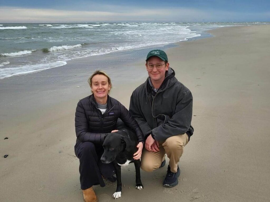 Family walking along the wide, flat sand of South Beach