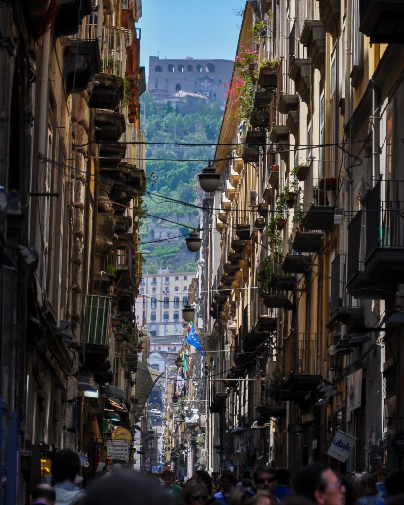 Narrow Spaccanapoli street lined with historic buildings and balconies in Naples’ old town