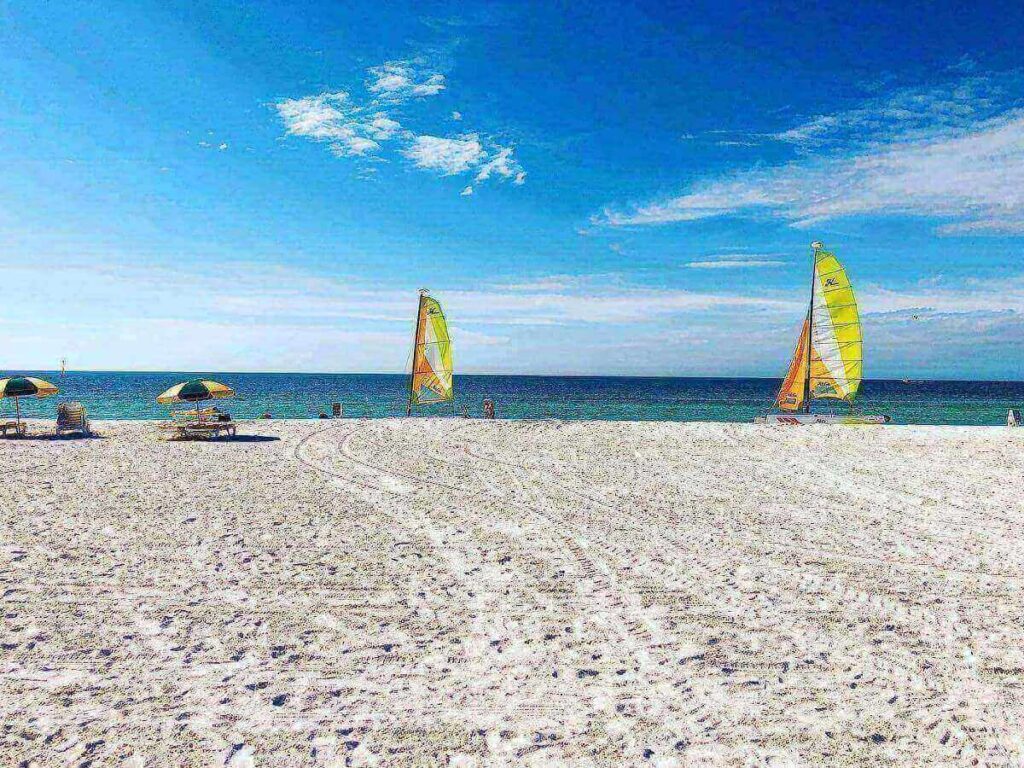 Visitors shelling along Tigertail Beach shoreline during low tide