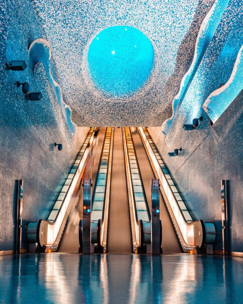 Blue-tiled ceiling and escalator at Toledo Metro Station, Naples’ famous underground art stop