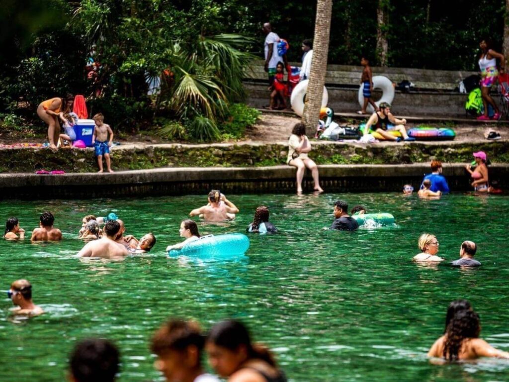 People swimming and relaxing in the clear water at Wekiwa Springs State Park