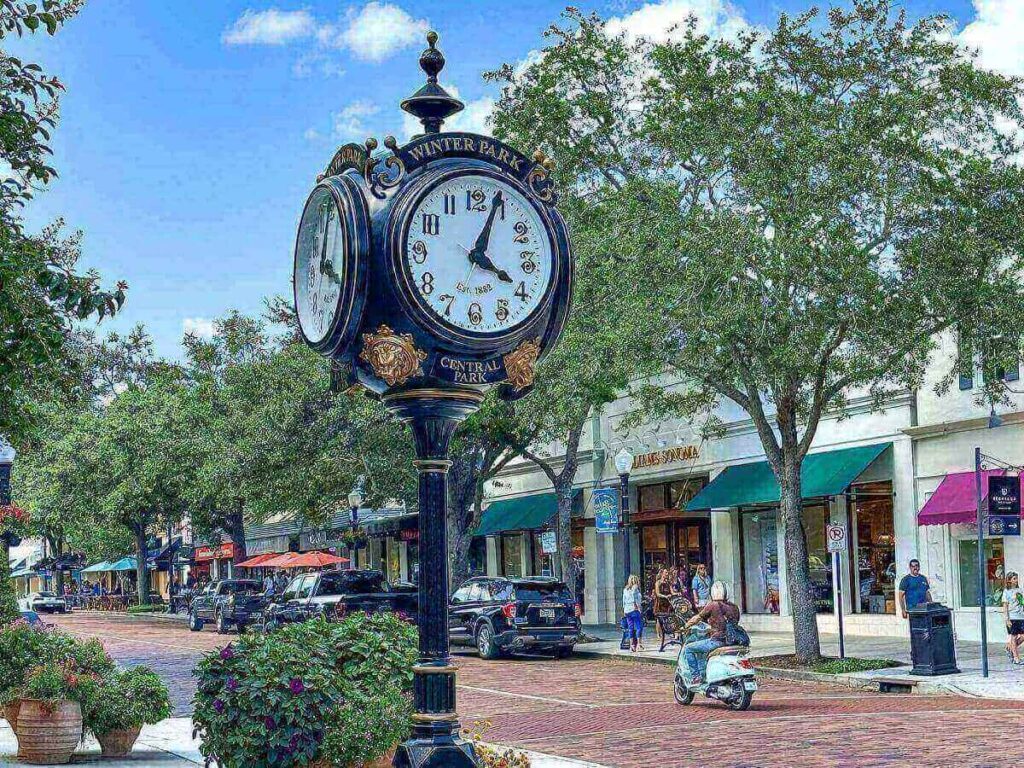 Street scene in Winter Park, Orlando with shops, trees, and pedestrians