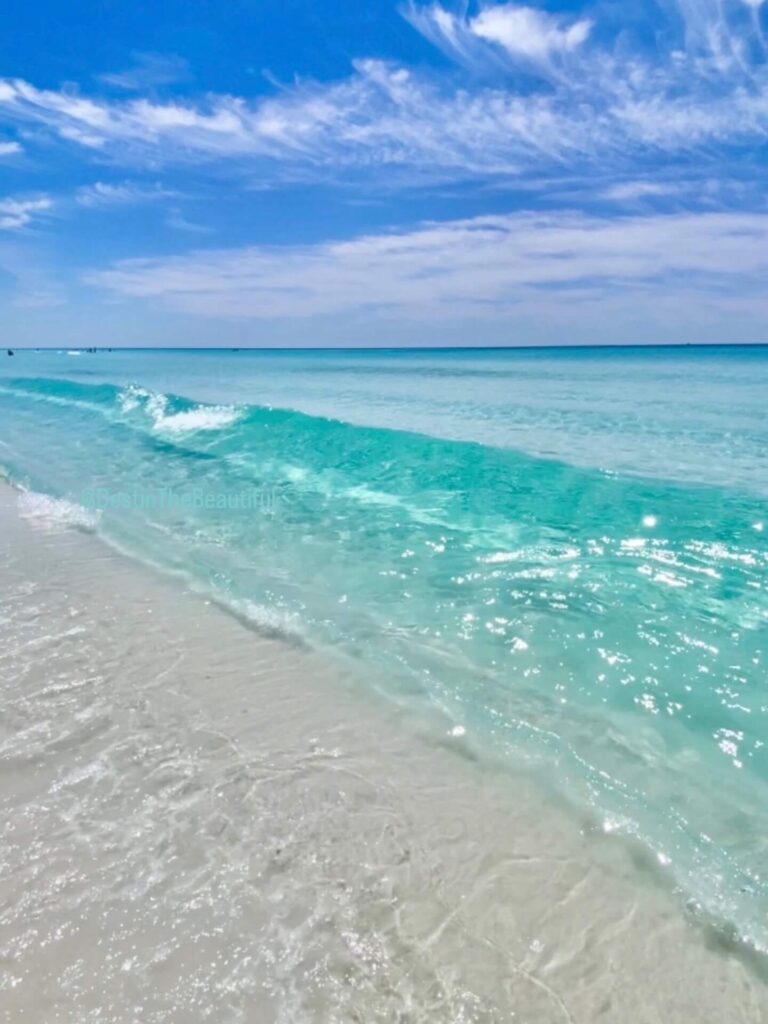 Emerald green water and white sand beach in Destin, Florida