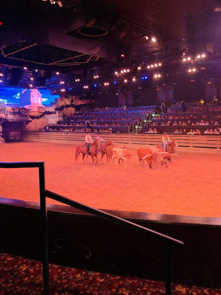 Horses and riders performing at Dolly Parton’s Stampede dinner show in Branson.