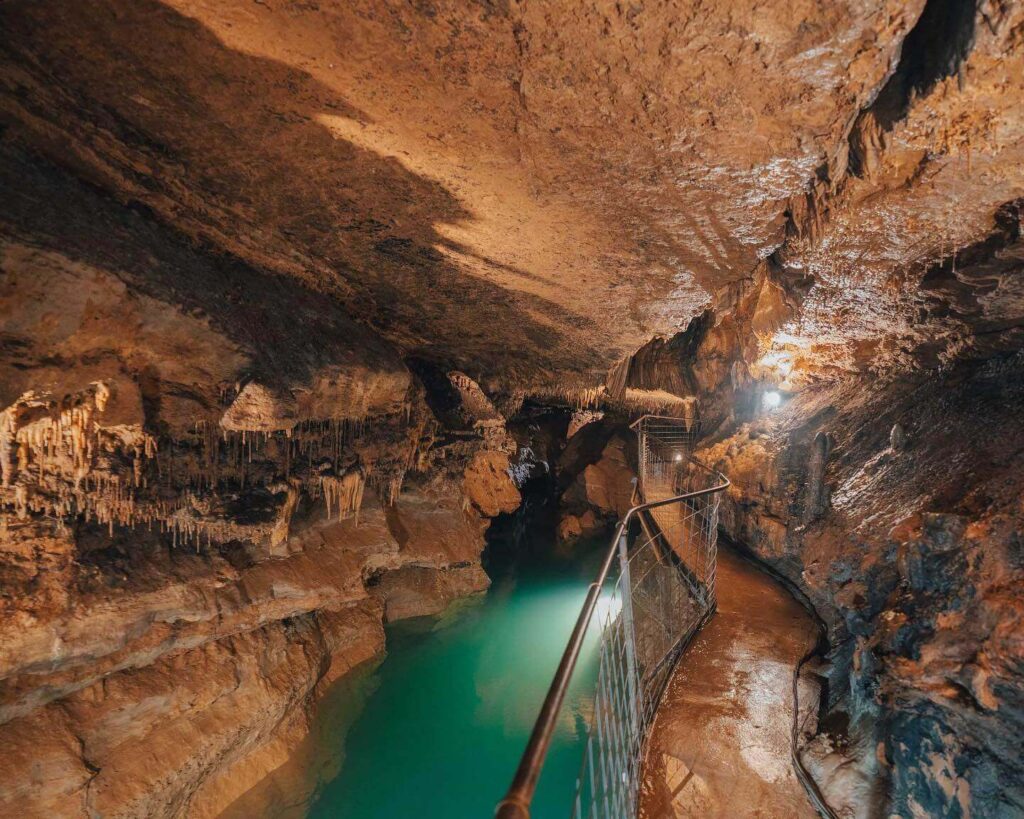 Stalactites and underground lake inside Cosmic Cavern near Eureka Springs Arkansas