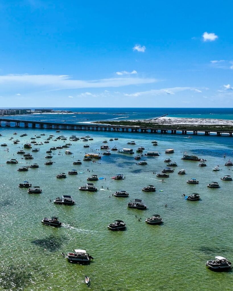 Pontoon boats and visitors at Crab Island in Destin