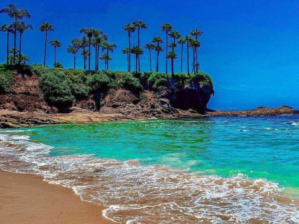 Crescent Bay Beach in Laguna Beach with cliffs and calm water