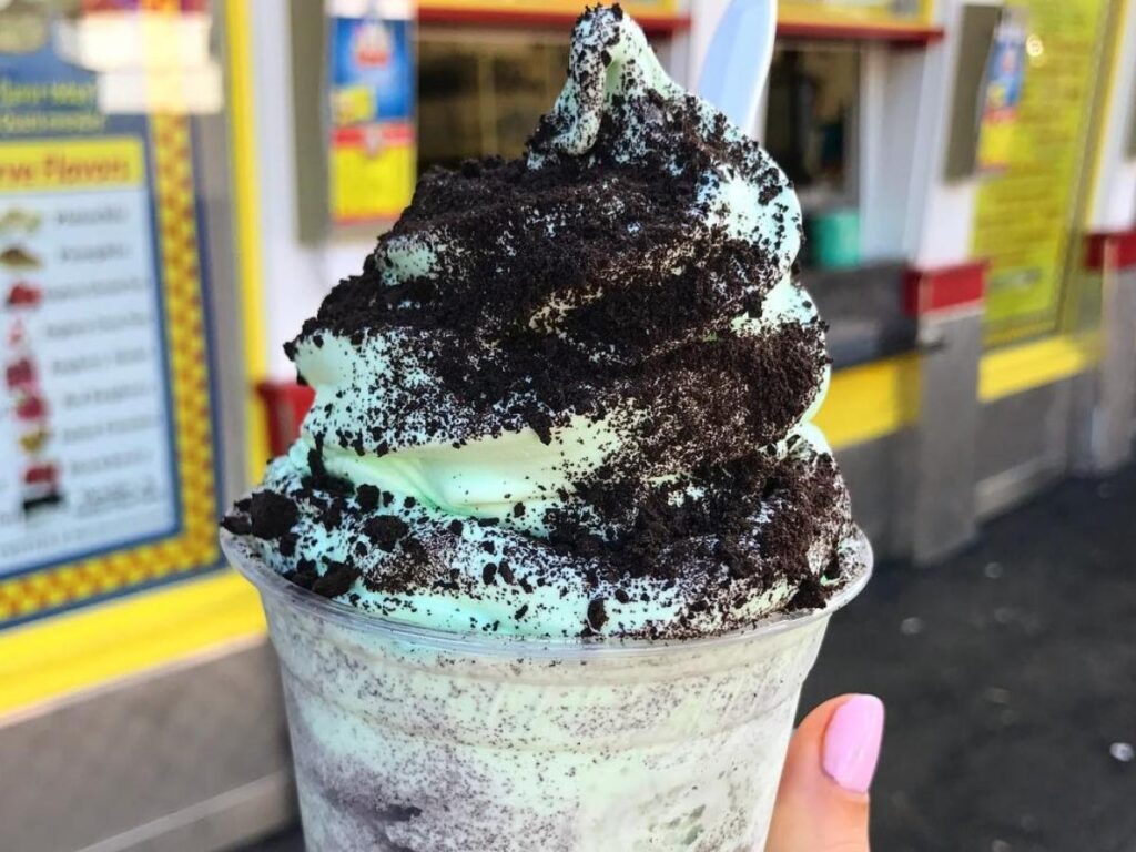 People walking along the Lake George waterfront with ice cream in the evening