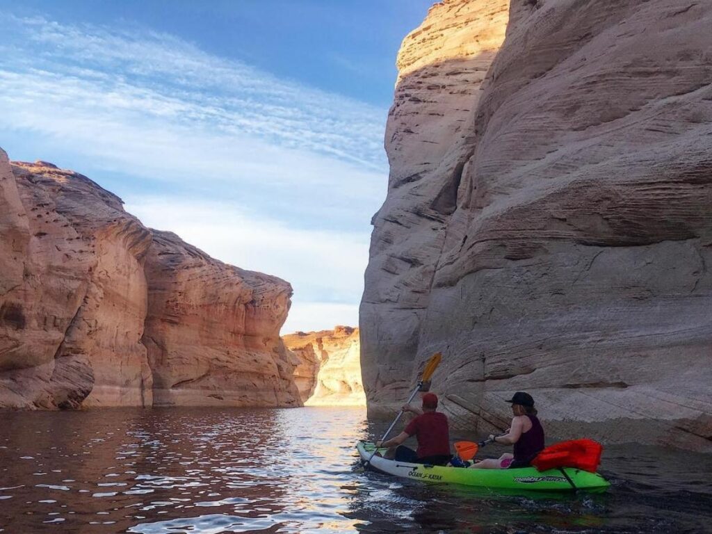 Kayaker entering a narrow canyon from Lake Powell
