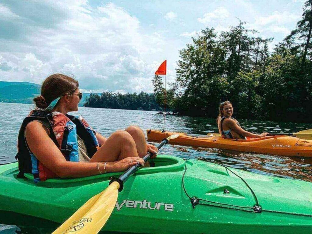 Kayaking on calm Lake George water early in the morning