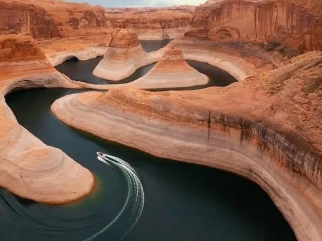 Kayakers paddling between canyon walls on Lake Powell