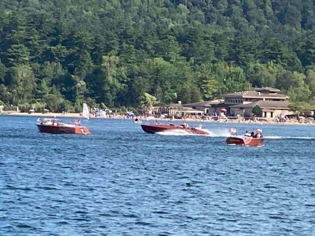 Boats and swimmers enjoying Lake George during peak summer season