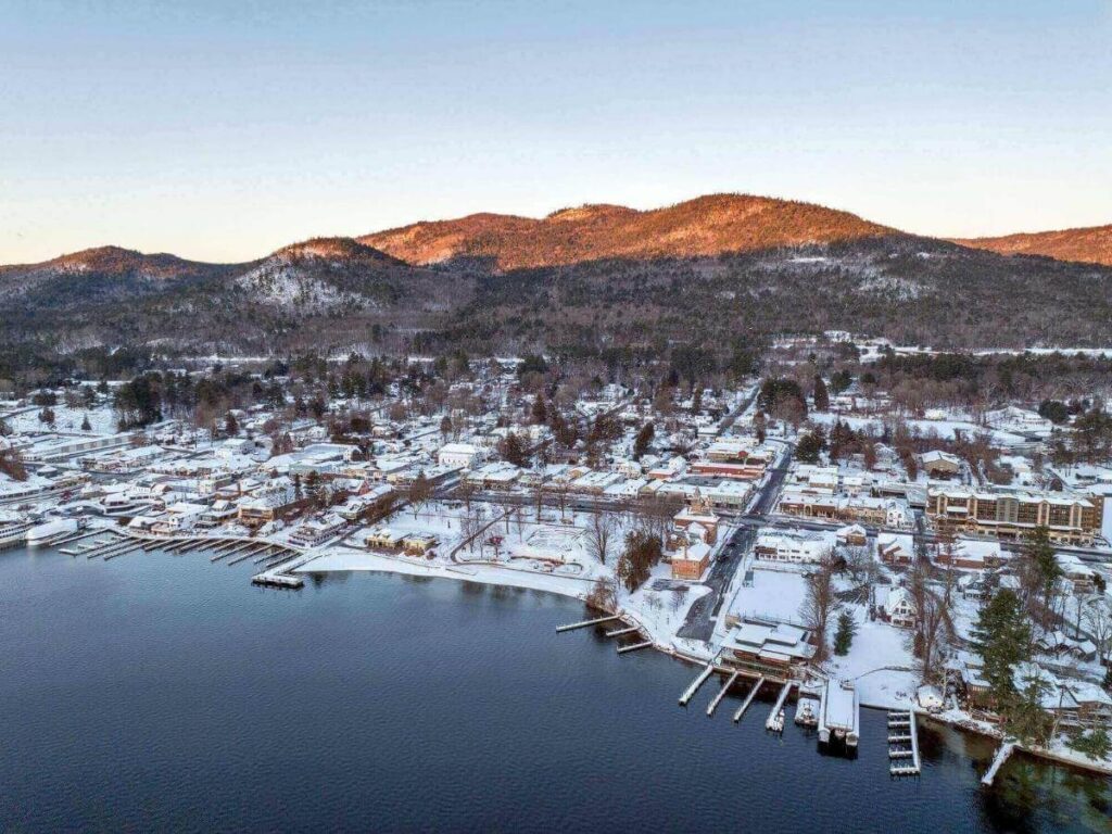 Lake George shoreline transitioning from village buildings to forested Adirondack landscape