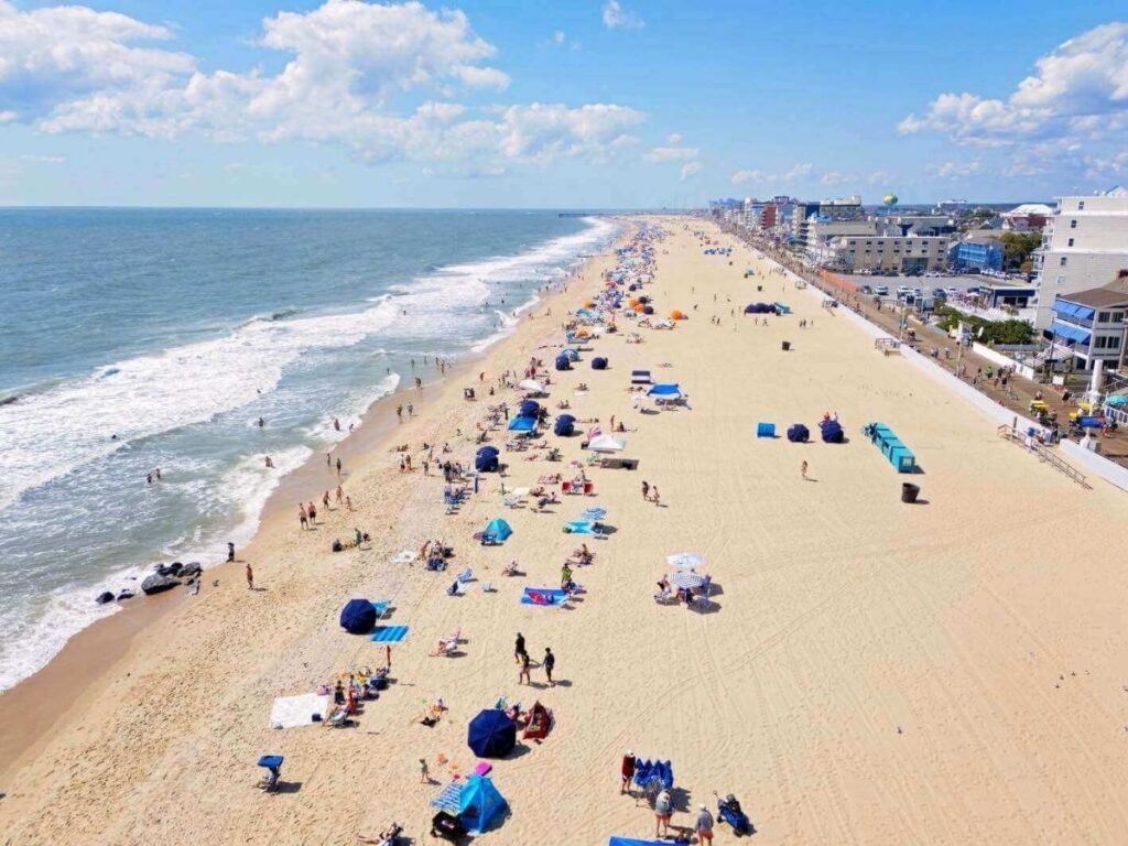 People walking along the Ocean City Boardwalk during a sunny afternoon