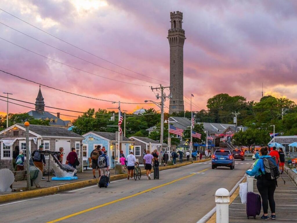 Evening atmosphere in Provincetown with glowing lights and people walking downtown