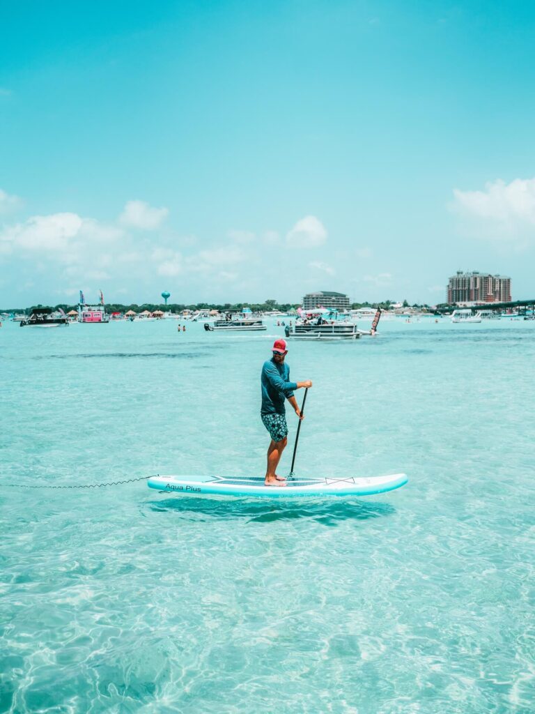 Paddleboarder exploring the calm waters of Destin, Florida
