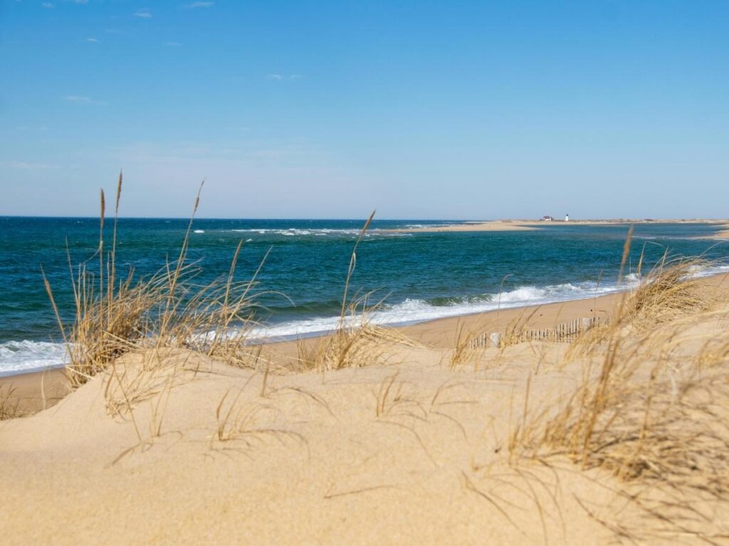 Wide sandy beach in Provincetown with dunes and open ocean in the background