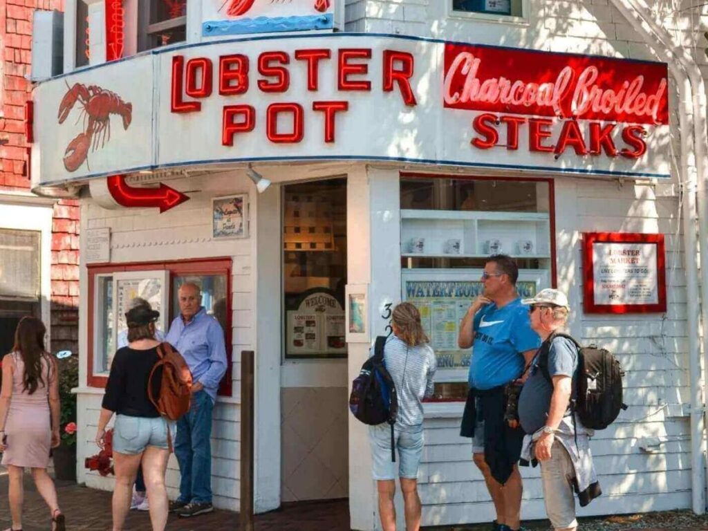 Evening scene on Commercial Street in Provincetown with people walking and lights glowing