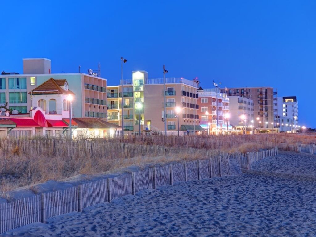 Rehoboth Beach boardwalk in the evening with lights and foot traffic
