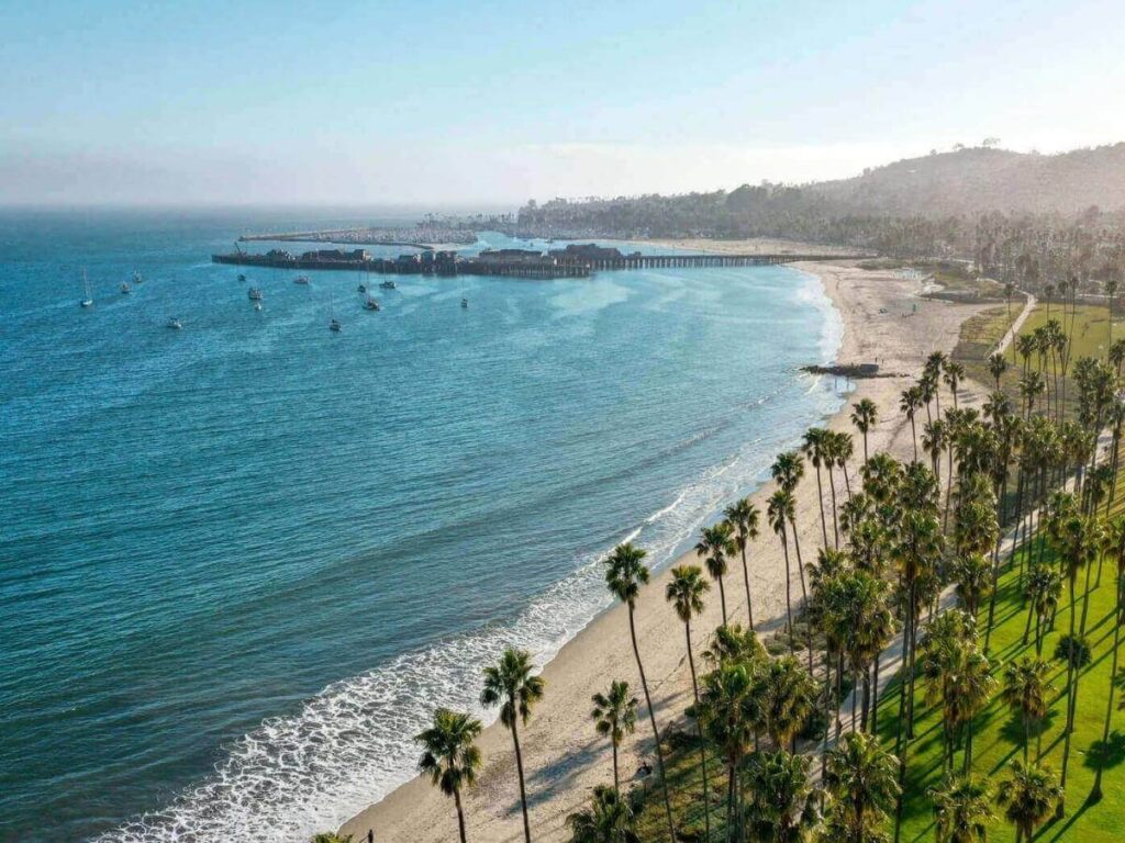 Beachfront walking path in Santa Barbara with ocean views and palm trees