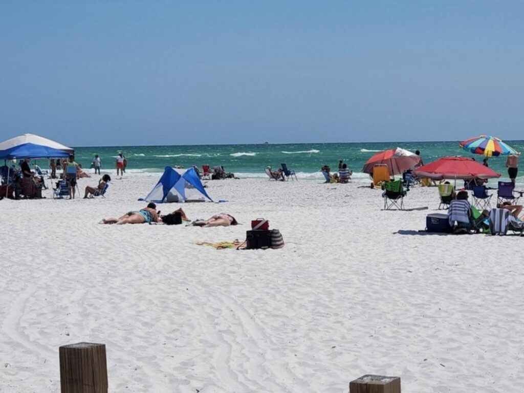 Relaxed beach day in Sarasota with towels on the sand and wide shoreline