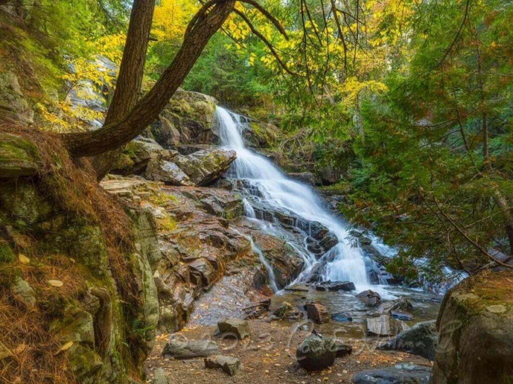 Shelving Rock Falls near Lake George with water flowing over rocks and trees