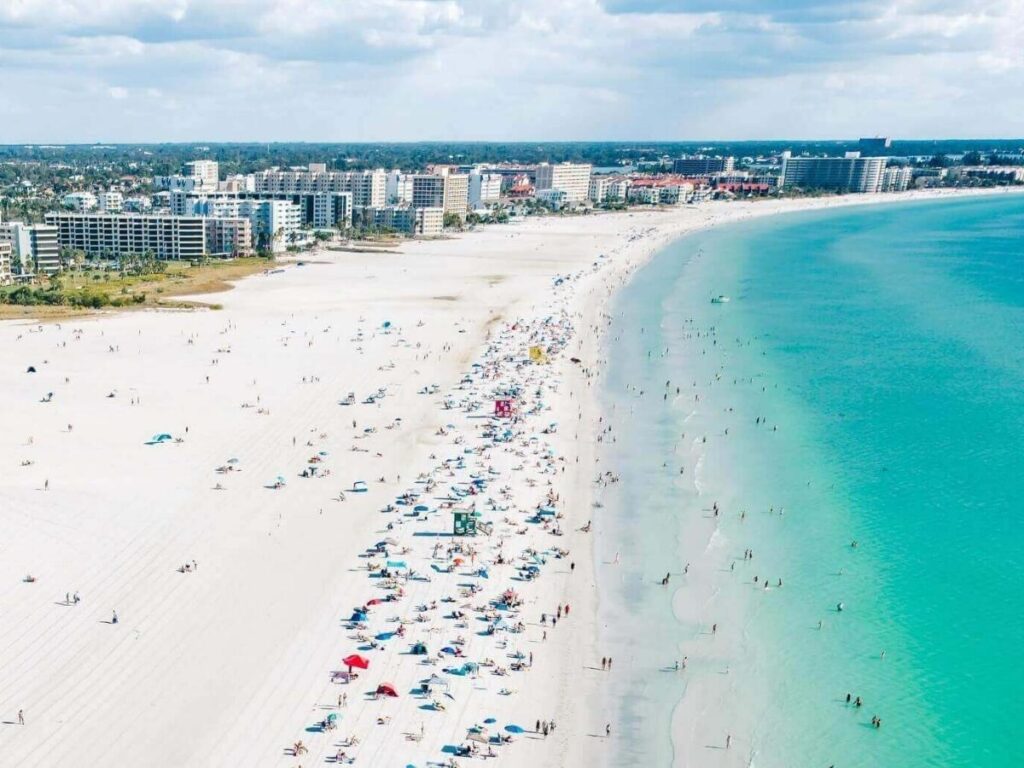 Morning light over Siesta Key Beach with wide shoreline and soft white sand