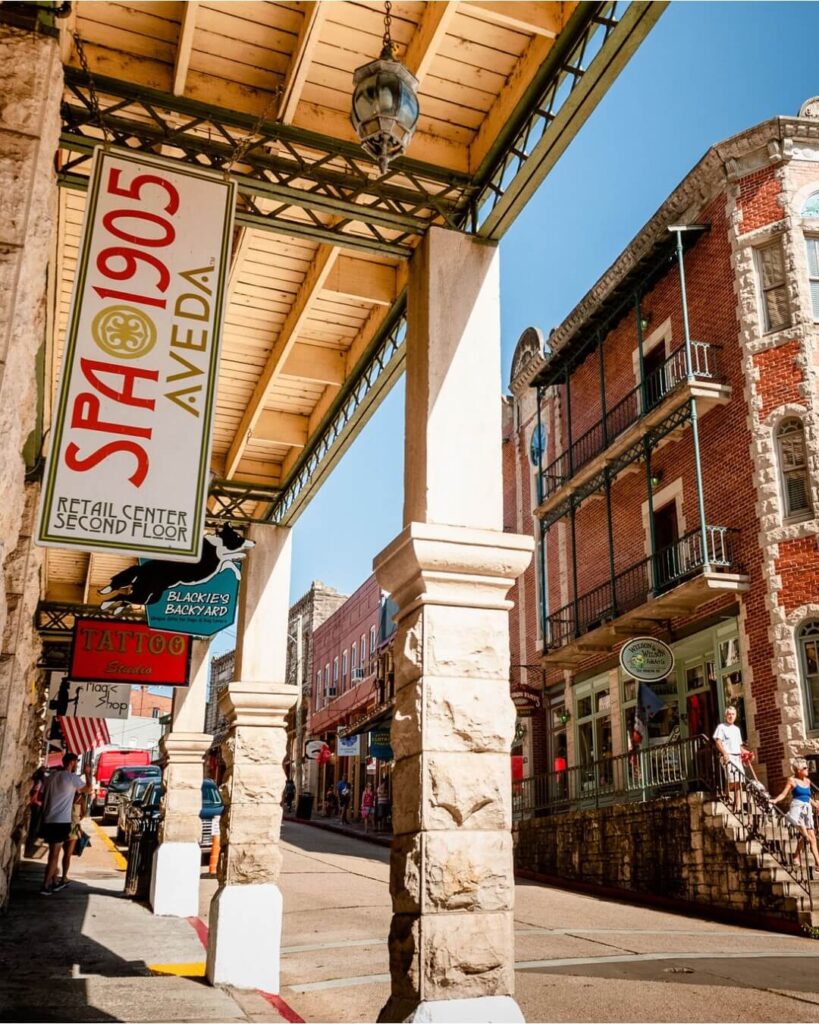 Spring Street in downtown Eureka Springs Arkansas with colorful historic Victorian buildings